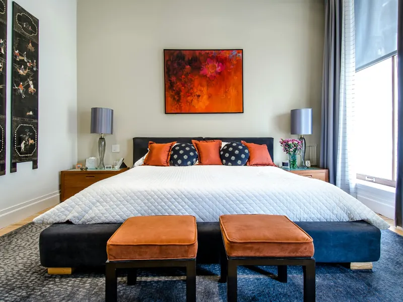 Luxury master bedroom suite with a city skyline view